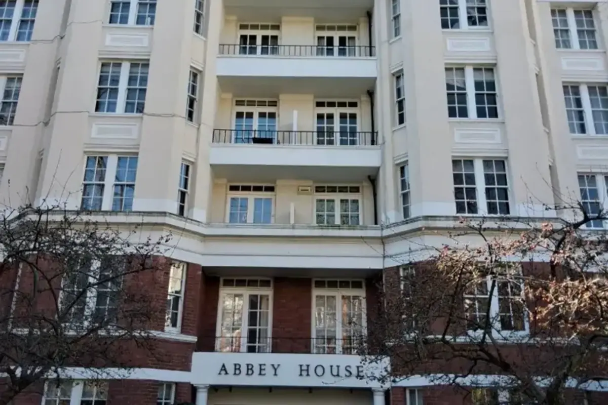 Period mansion block with balconied stone facade