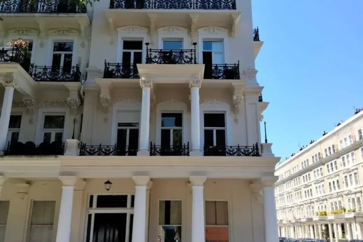 White stucco townhouse with a black panelled entrance door